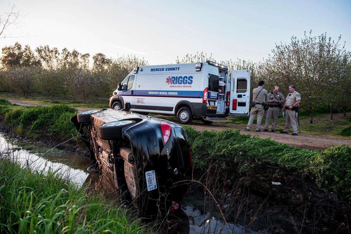 The California Highway Patrol and Riggs Ambulance Service respond to the scene of crash near the intersection of Bellevue Road and M Street just outside the city of Merced Calif., on Monday, March 18, 2019. According to CHP Officer Jesse Talbot, a Nissan Versa driven by a 21-year-old Merced woman, was traveling eastbound on Bellevue Road when for an unknown reason the driver drove onto the shoulder of the road. The driver of the vehicle attempted to steer the car back onto the road and lost control overturning into a drainage ditch. The driver of the vehicle was taken to Mercy Medical Center with minor injuries, according to Talbot.
