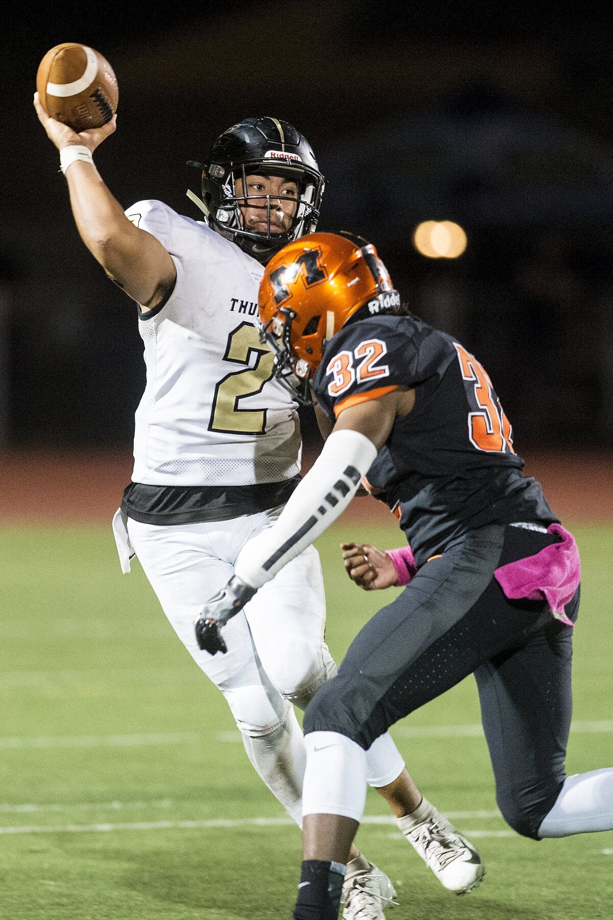 Buhach Colony senior quarterback Brandon Ruiz (2) gets rid of the ball just before he is hit by Merced senior Ke’saun Eddings (32) during a game at Veterans Stadium in Merced, Calif., on Friday, Oct. 5, 2018. The Bears beat the Thunder 55-14.