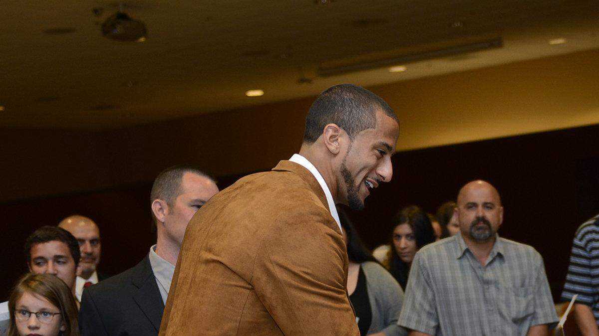 San Francisco 49ers quarterback Colin Kaepernick greets Hilmar high school football player Joseph Bello on Friday morning (05-02-14) after the 21st Annual Turlock Mayor's Prayer Breakfast at the Larsa Banquet Hall in Denair, Ca.