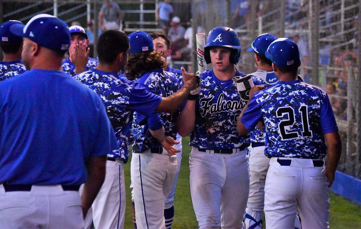 Jacob Weiss is congratulated by his Atwater teammates after scoring a run during the Falcons’ 12-6 win over Downey on Tuesday, April 23, 2019 at Memorial Ballpark in Atwater, Calif.