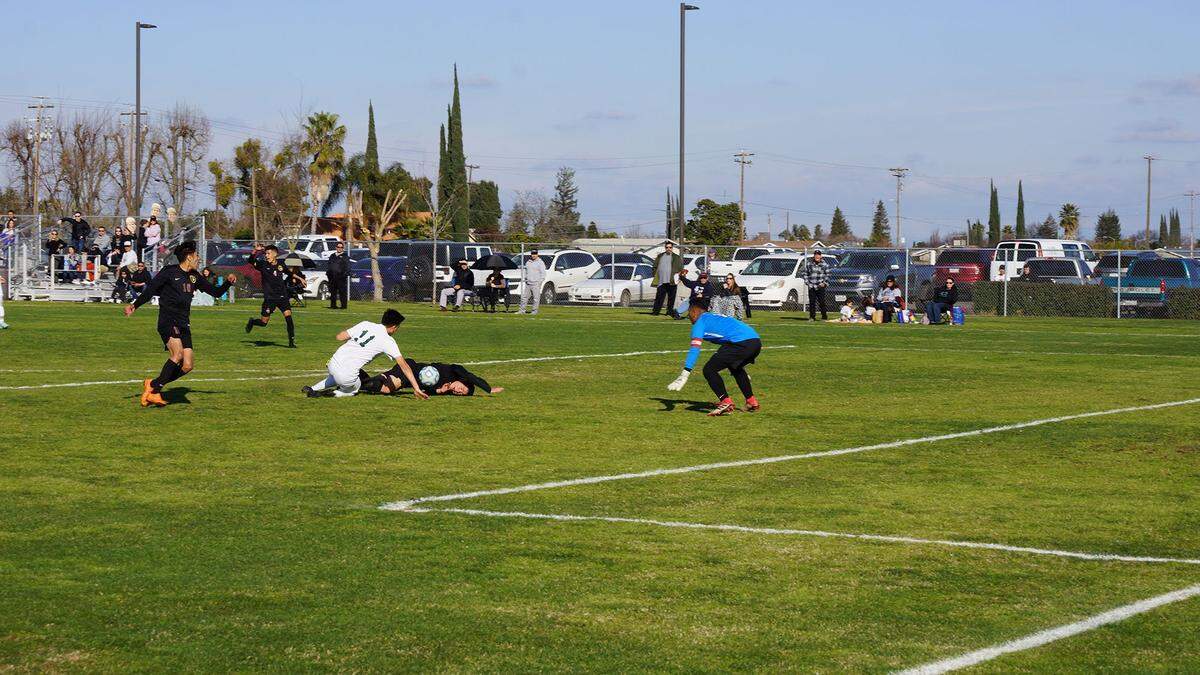 Livingston’s Carlos Valencia is fouled by Liberty Ranch’s Ernesto Becerra during the first half of the Wolves’ 2-0 win in the Sac-Joaquin Section Division IV semifinal matchup at Livingston High. Photo courtesy of Scott Winton.
