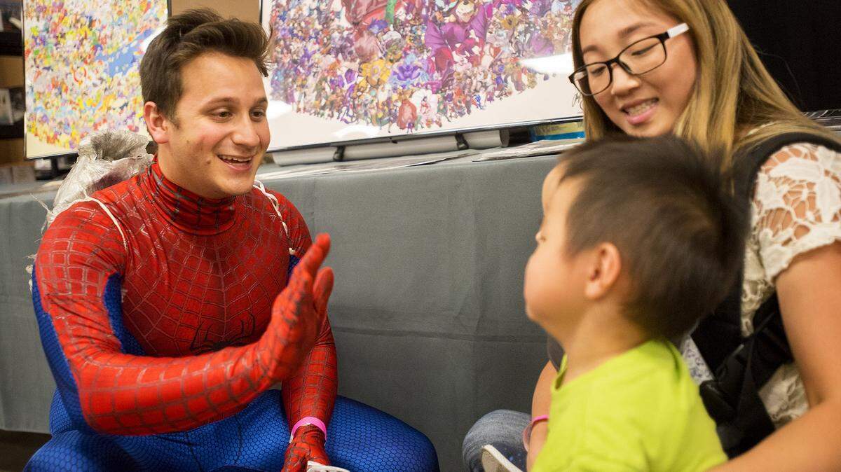 Justin Alvarez, 26, of Modesto, speaks to children dressed as Spiderman during the California Republic Comic Con at the Merced County Fairgrounds in Merced, Calif., on Saturday, Sept. 15, 2018.