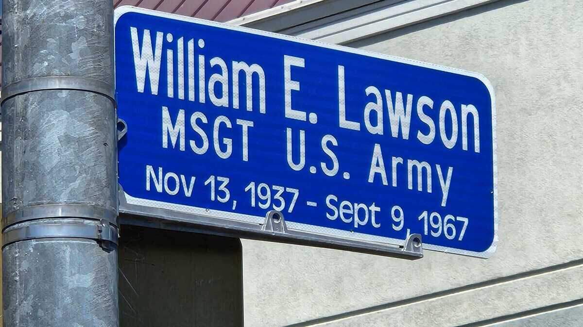 A small blue sign juts out from a pole. 