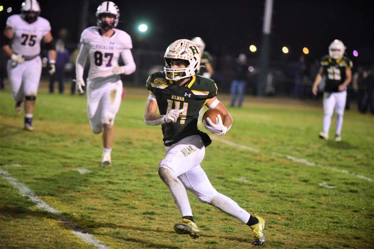 Hilmar High running back Luis Vargas runs the ball against Escalon during a playoff game on Friday, Nov. 11, 2022 at McSweeney Field in Hilmar, Calif.