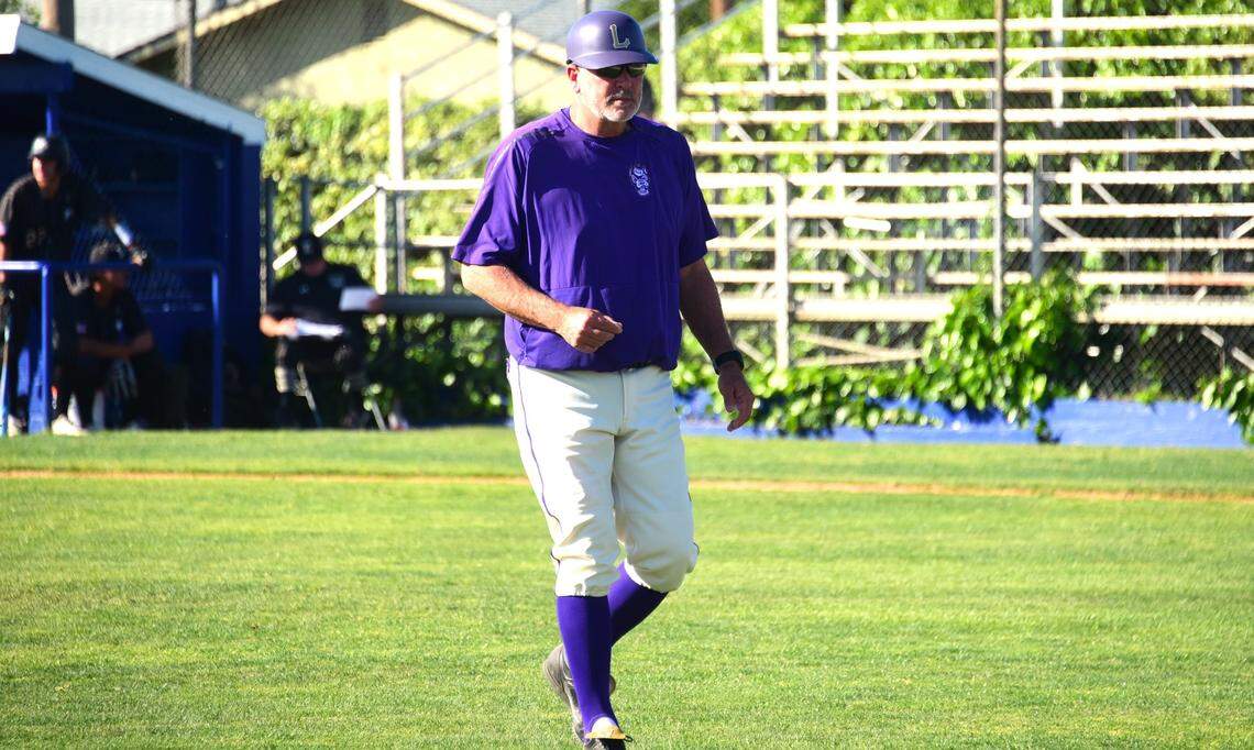 Livingston High baseball coach Matt Winton makes his way back to the dugout after making a pitching change during a game against Enochs on Tuesday, April 2, 2024 at Memorial Ballpark in Atwater, Calif.