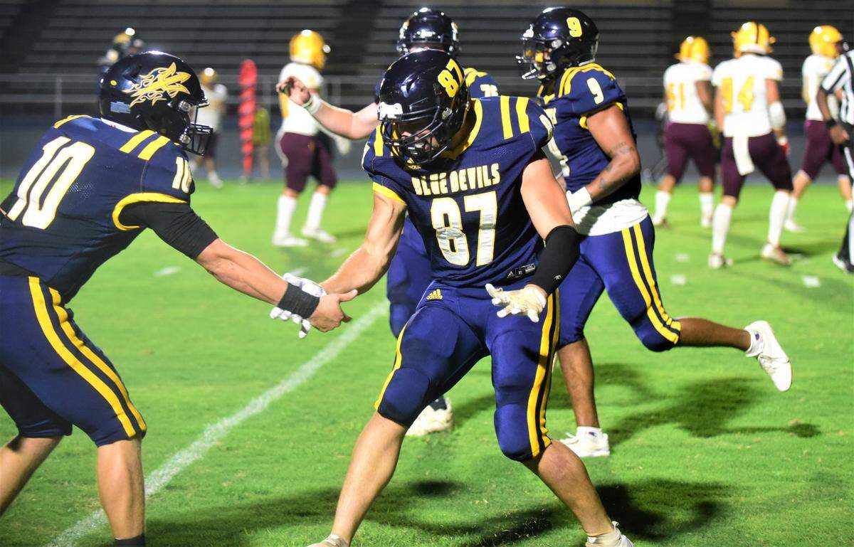 Merced College tight end Tyler Woolsey (87) celebrates with quarterback Aiden Meyer after scoring a touchdown during a 54-7 win over Hartnell College on Saturday, Oct. 1, 2022 at Merced College.