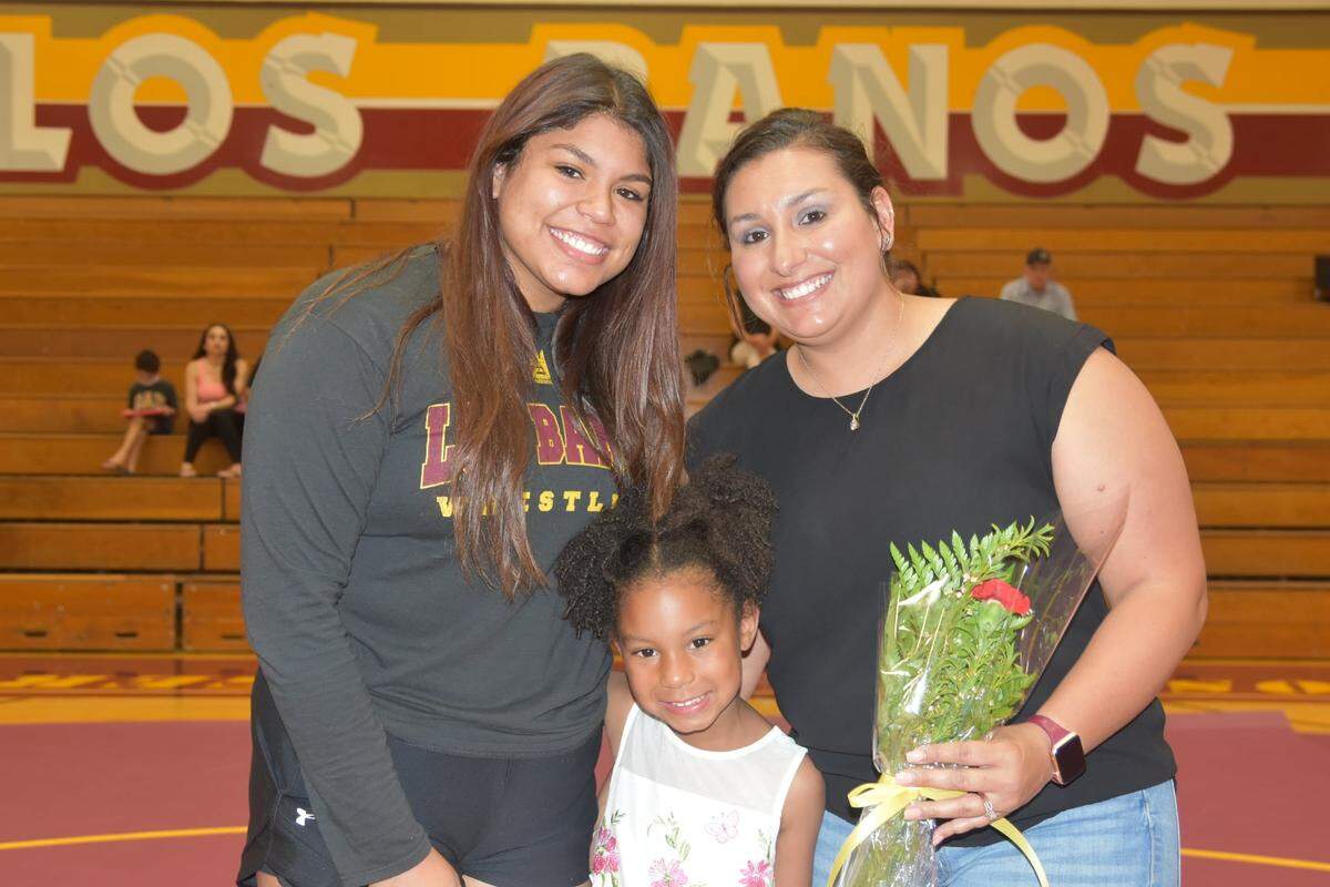 Los Banos High senior Victoria Zevada (left), shown here during senior night with family, won the 191-pound state championship at the 2021 California State Finals Invitational this past weekend at the Fresno Fairgrounds.