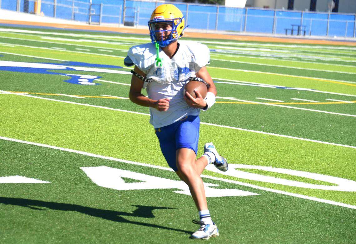 Dos Palos High School senior receiver Sixto Ibarra hauls on a catch during practice on Tuesday, Aug. 13, 2024.