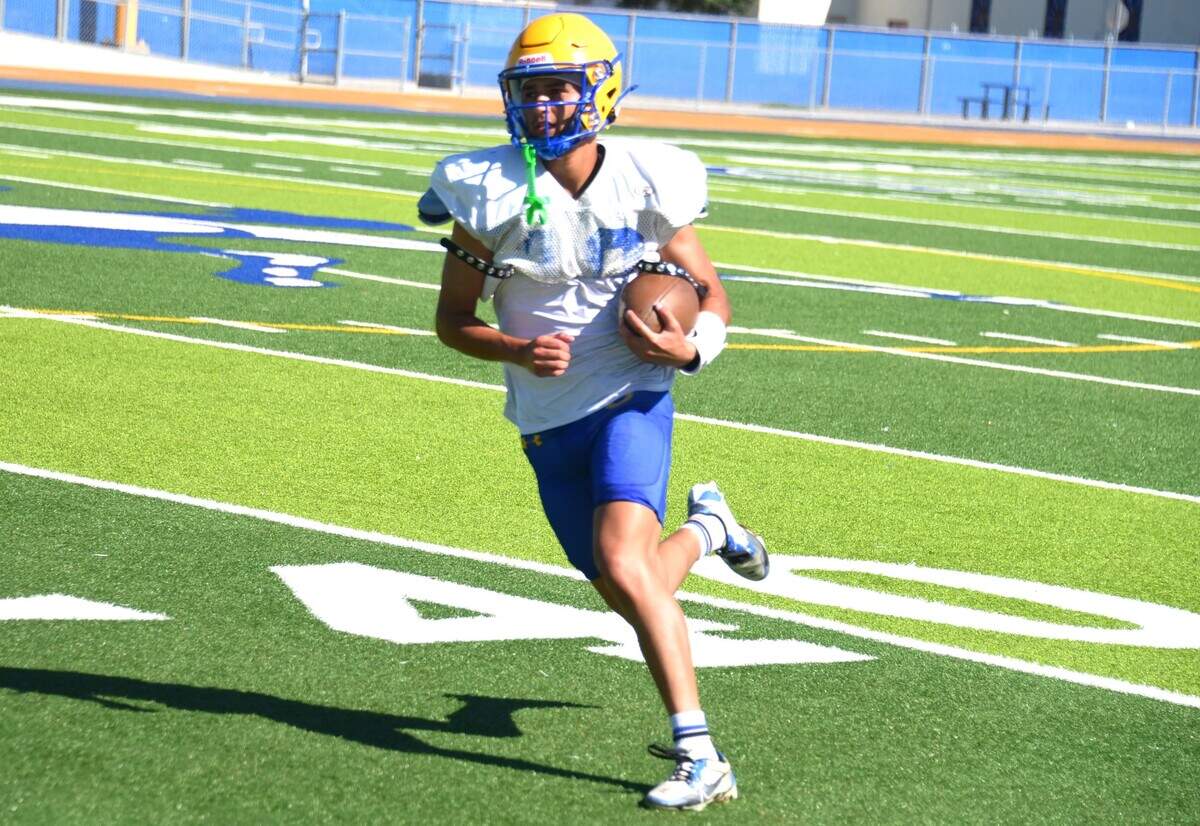 Dos Palos High School senior receiver Sixto Ibarra hauls on a catch during practice on Tuesday, Aug. 13, 2024.