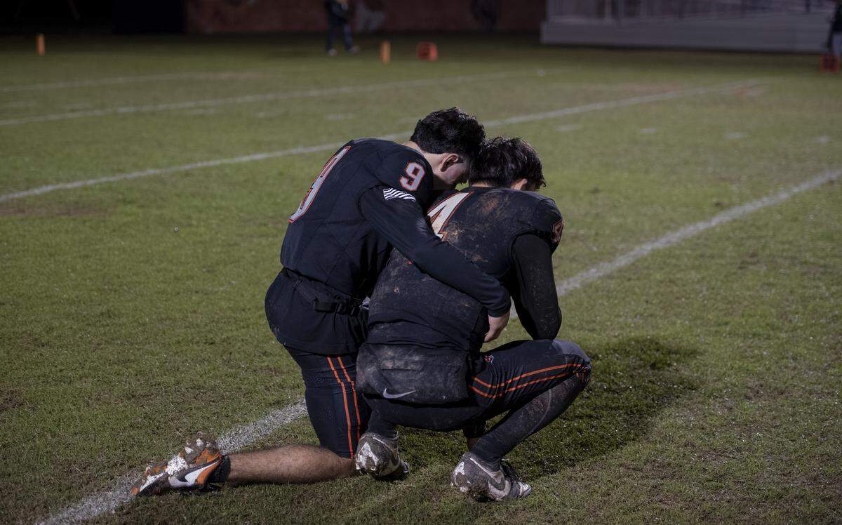 Merced players embrace on the field after a 26-25 loss to Vanden in a Division III playoff game Friday, Nov. 14, 2025, in Merced. The Bears’ season ended at 10-1 after one of the best regular-season runs in program history.