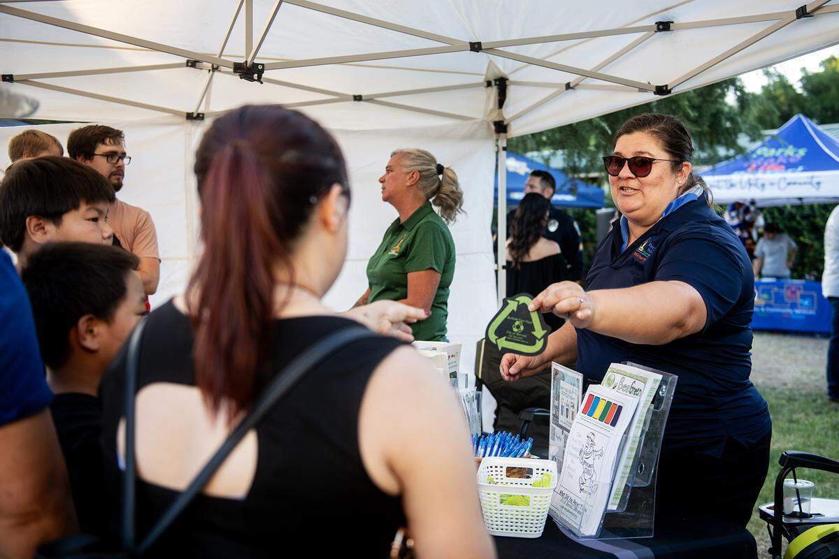 City of Merced Recycling Coordinator Monique Gama, speaks with members of the community during the National Night Out event at Applegate Park in Merced, Calif., on Tuesday, Aug. 5, 2025. 