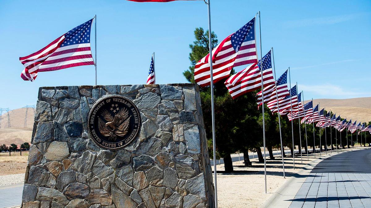 American flags line the road at the entrance to the San Joaquin Valley National Cemetery in Santa Nella, Calif., on Thursday, May 27, 2021.