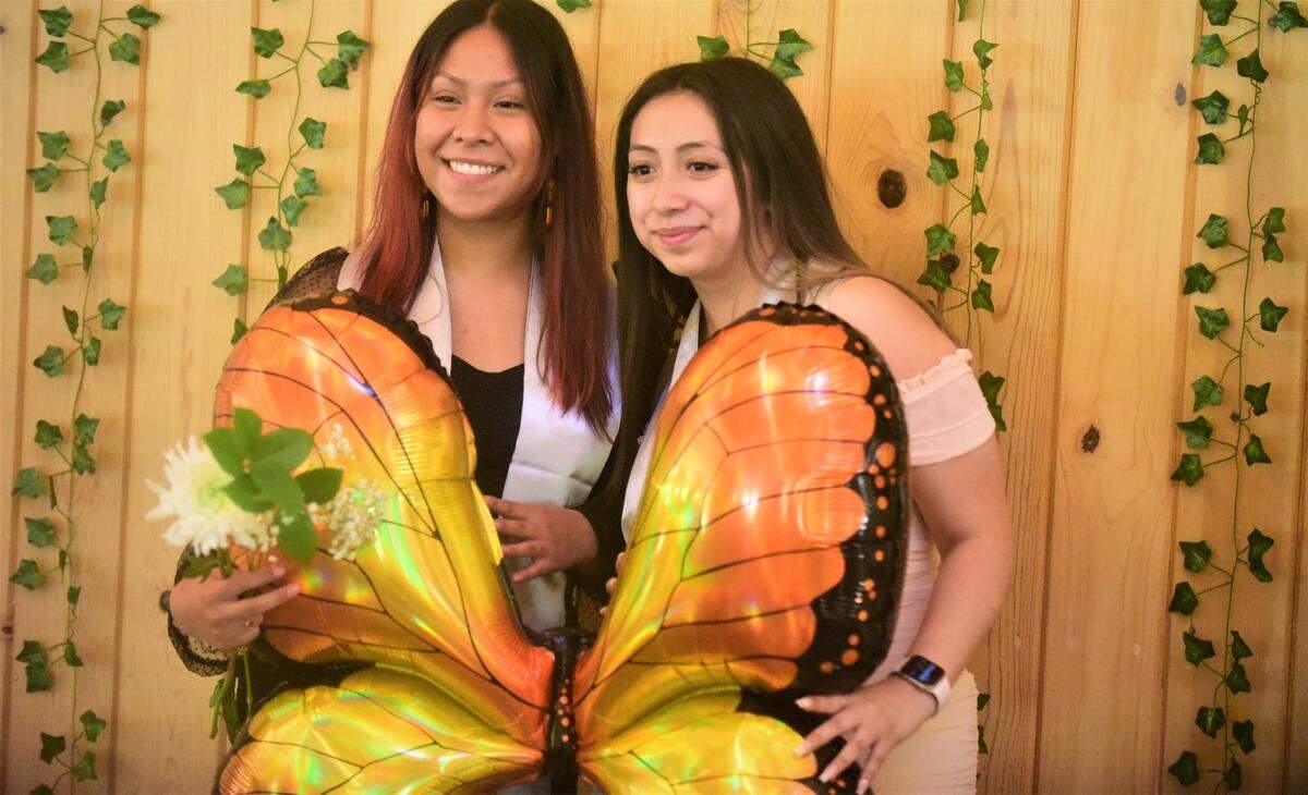 UC Merced students Beatriz Lopez (left) and Elizabeth Meza Torres pose for photos during a celebration recognizing UC Merced undocumented students who are graduating this weekend on Friday, May 13, 2022 at UC Merced in Merced, Calif.