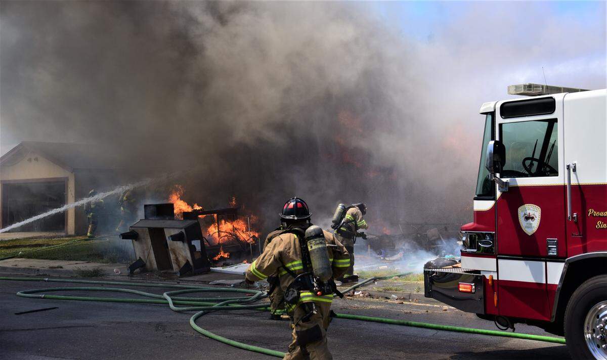 Fire crews battle a blaze that damaged two homes on De Anza Court on Friday, July 28, 2023.