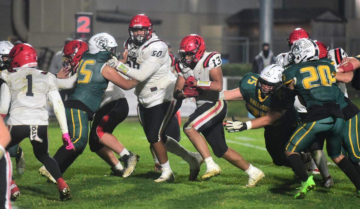 Woodland Christian running back Keigi Kungu runs the ball during the Cardinals’ 44-0 win over the Bulldogs in the Sac-Joaquin Section Division VII semifinals on Friday, Nov. 18, 2022 at Le Grand High School.