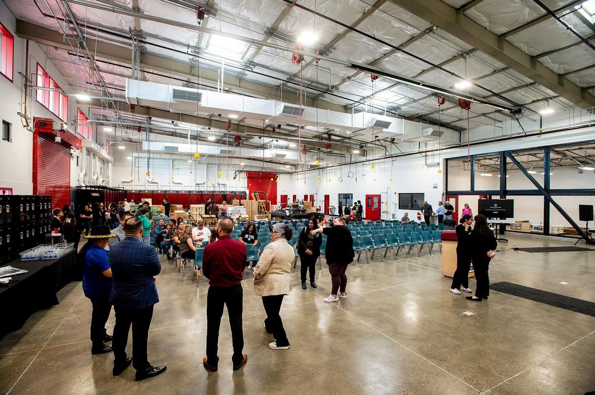 People tour the new Career and Technical Education building on the Delhi Unified School District campus in Delhi, Calif., on Tuesday, April 9, 2024. According to the district, classes in agricultural mechanics and welding will be offered to students beginning in the fall of 2024.