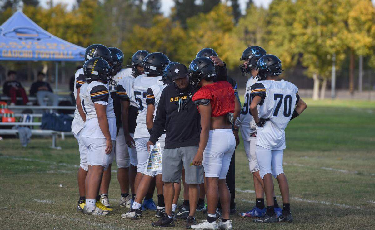Senior quarterback Sergio Mendoza talks with head coach Xavier Ramirez during a mid-October practice. Ramirez has emphasized accountability, communication and leadership throughout the program.