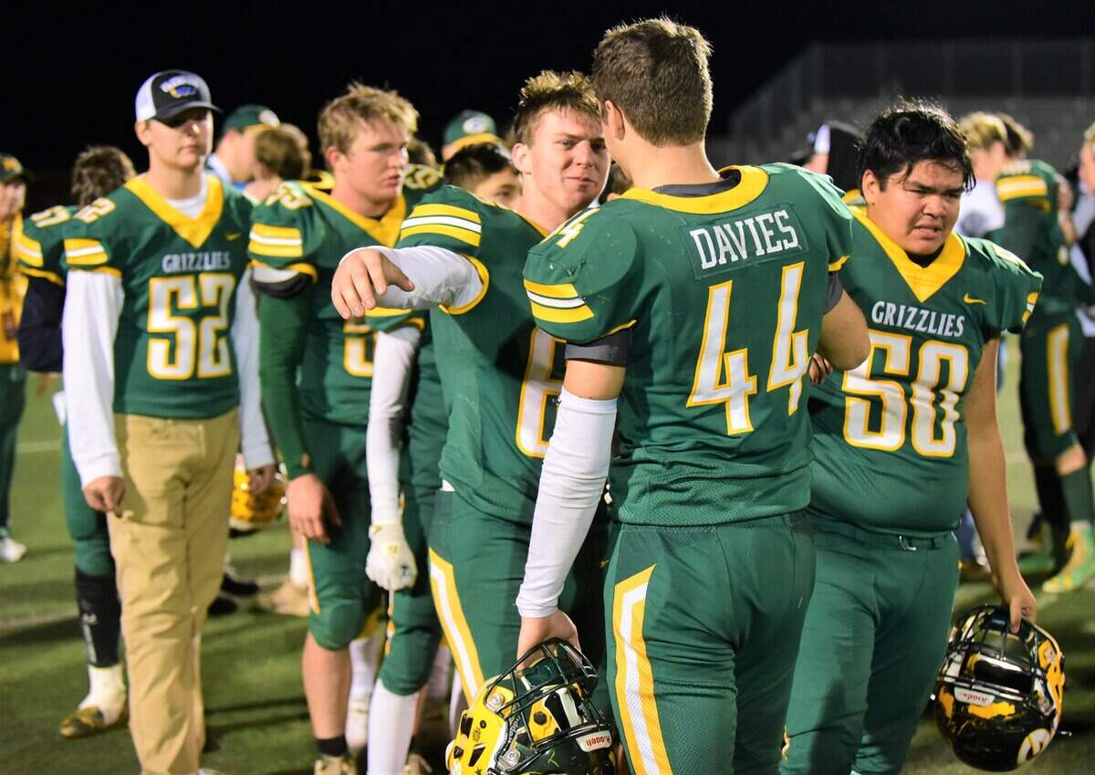 Mariposa High senior J.C. Davies (44) hugs one of his teammates after the Grizzlies lost to Lincoln 21-14 in the Northern California Regional Division 7-AA Championship at Veterans Stadium on Friday, Dec. 6, 2019.