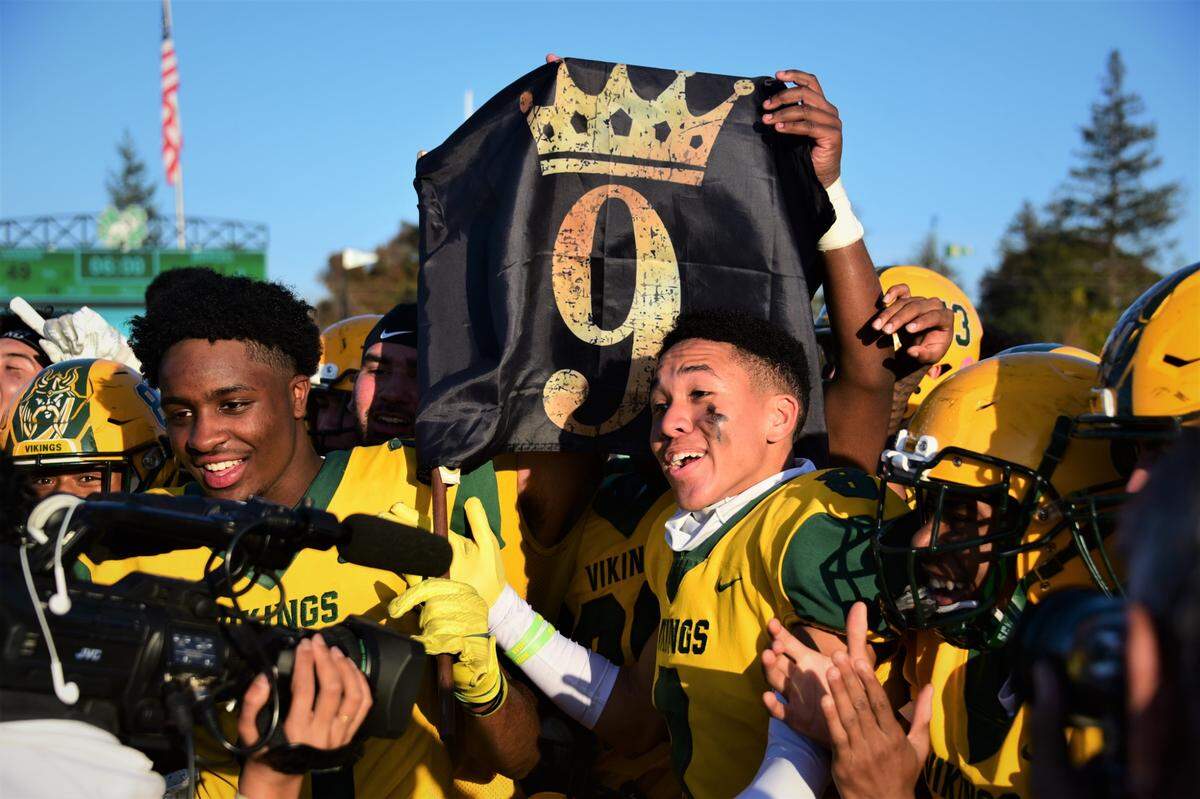 Vanden’s Jamai East (left) and Justin Pringle (8) celebrate the Vikings 49-21 win over Merced in the Sac-Joaquin Section Division IV championship game on Saturday, Nov. 27, 2021 at St. Mary’s High School in Stockton, Calif.