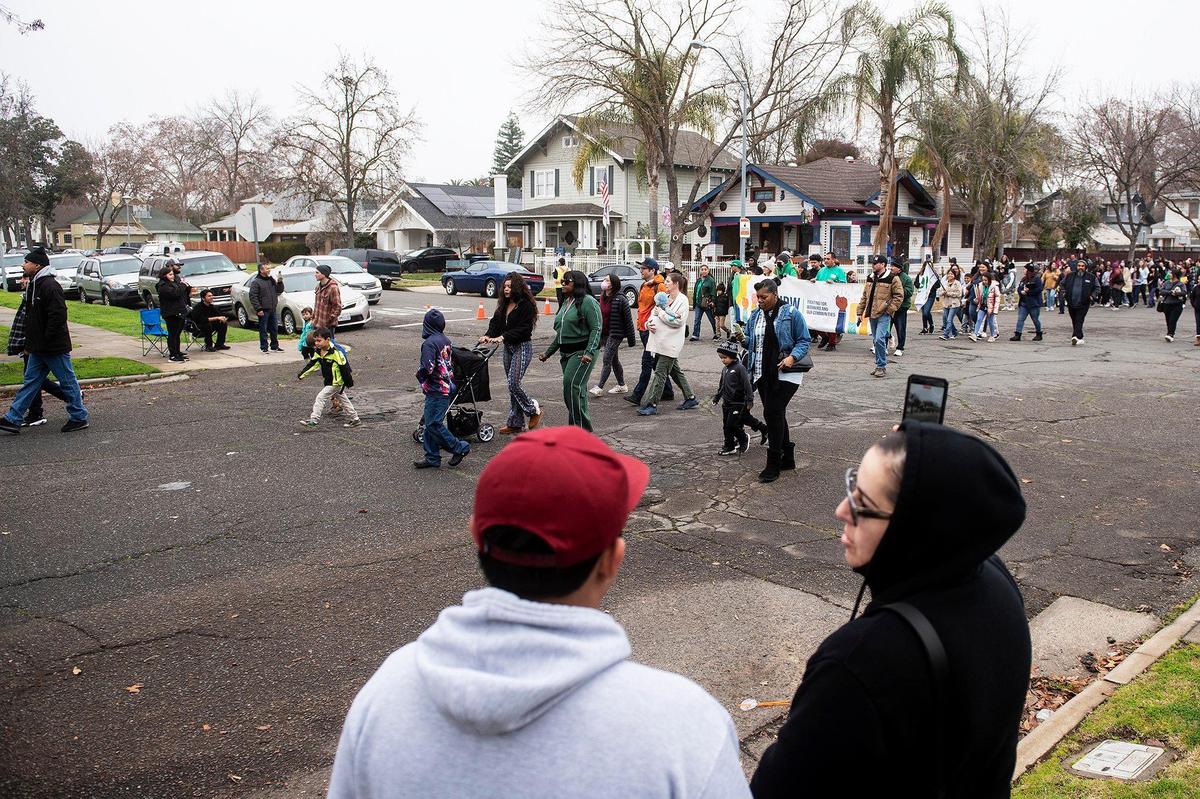 Marchers walk along Martin Luther King Jr. Way during the annual Peace and Unity March to honor the legacy of late civil rights leader Rev. Dr. Martin Luther King Jr. in Merced, Calif., on Monday, Jan 15, 2024.
