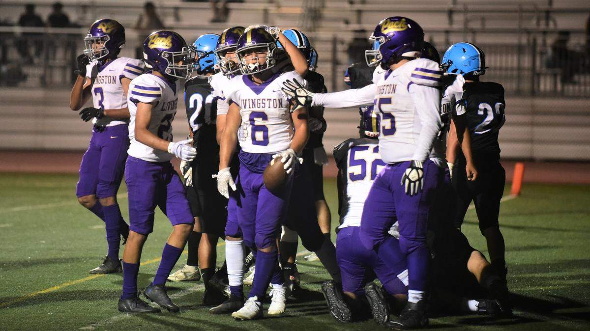 Livingston High teammates congratulate running back Carlos Baez after his third touchdown of the night during a 48-20 win over El Capitan on Friday, Sept. 10, 2022 at Veterans Stadium in Merced, Calif.