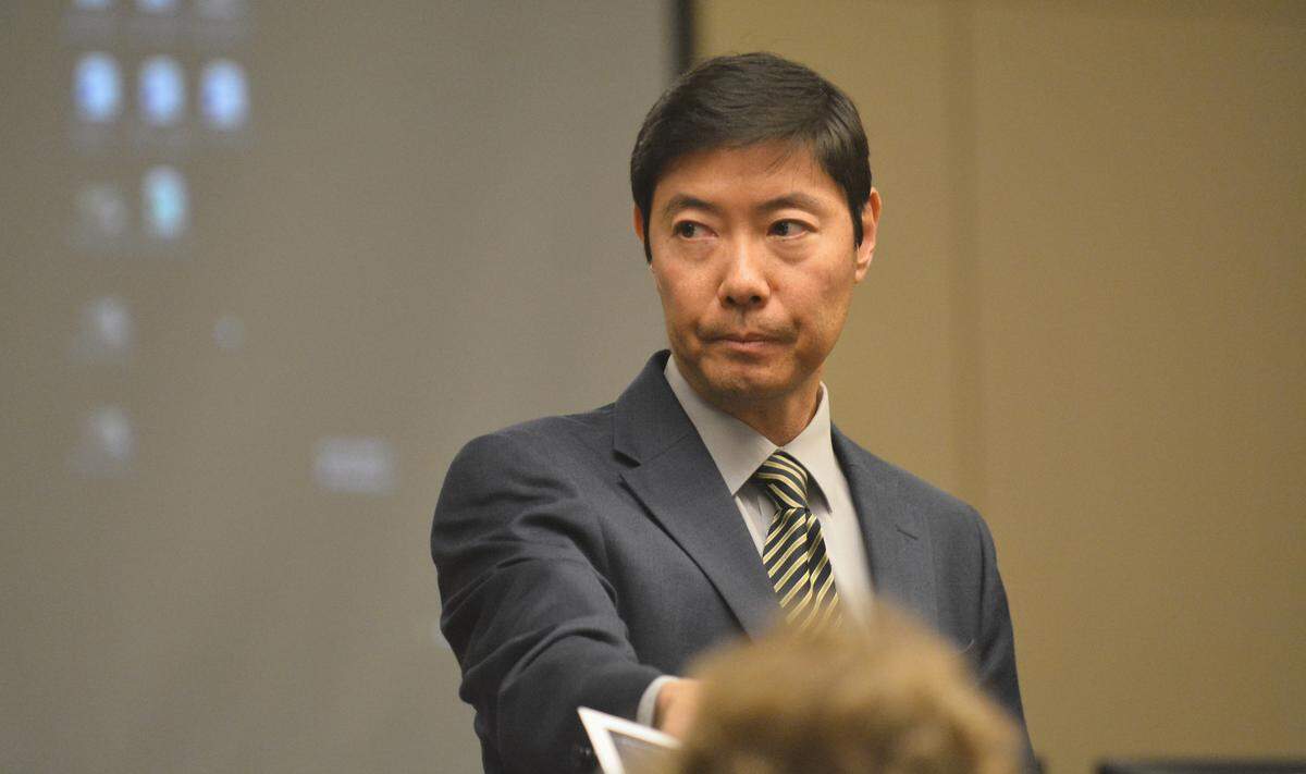 Merced County Deputy District Attorney Thomas Min hands a trial exhibit to Eric Cruz Madero’s attorney, Susan Albertoni, during the 22-year-old Merced defendant’s murder trial on Wednesday, Aug. 14, 2019, in Merced Superior Court.