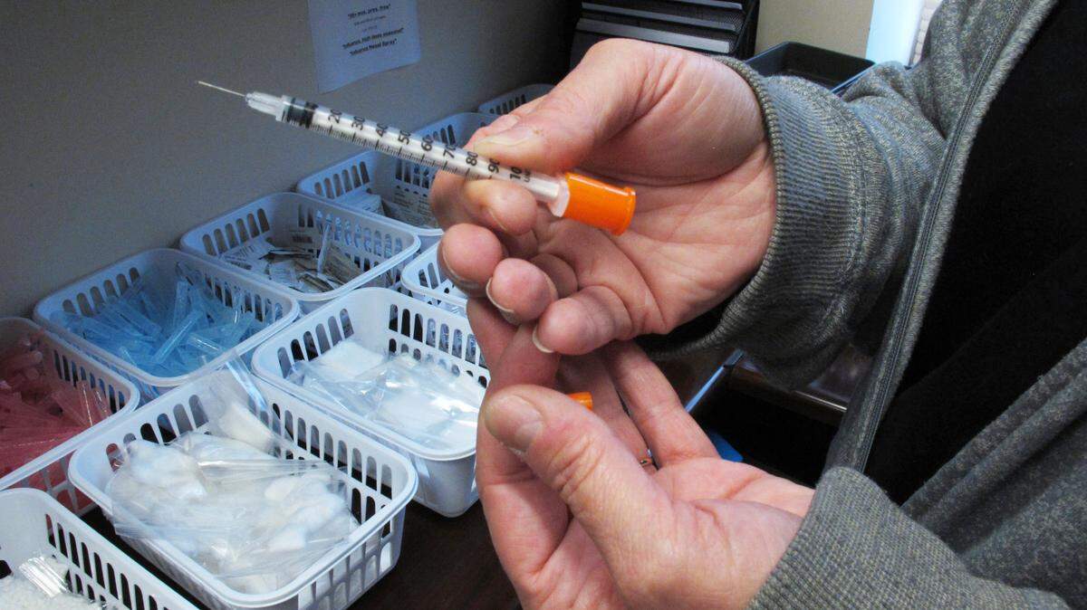 FILE - In this March 24, 2016 photo, a nurse for eastern Indiana’s Fayette County holds one of the syringes provided to intravenous drug users taking part in the county’s state-approved needle exchange program at the county courthouse in Connersville, Ind. The effort is in response to a hepatitis C outbreak among IV drug users. In a report released by the Centers for Disease Control and Prevention on Thursday, May 11, 2017, hepatitis C infections have nearly tripled since 2010 _ an increase mainly due to the heroin epidemic. (AP Photo/Rick Callahan)