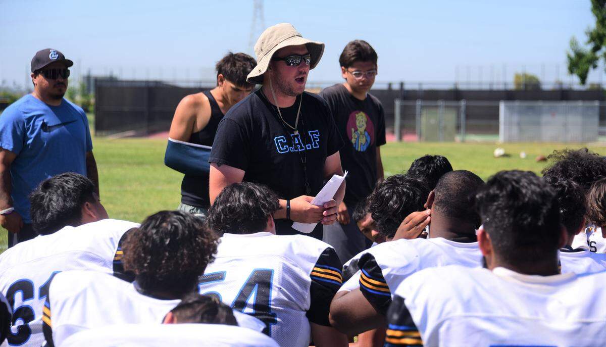 First-year head coach Jordan Irsik talks to the El Capitan High School football team at the end of practice on Thursday, Aug. 10, 2023.