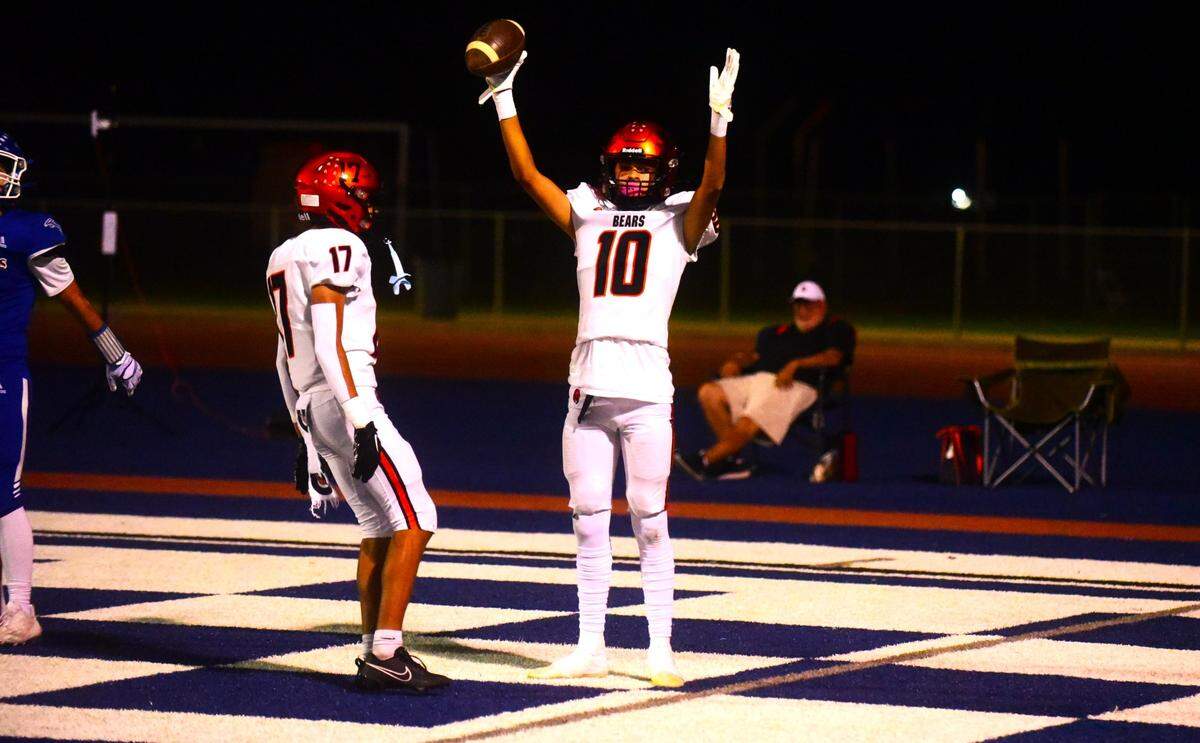 Merced High School receiver Antonio Aaron (10) raises his hands to celebrate his first of two touchdown catches during the Bears’ 48-14 win over the Falcons in Santa Fe Bowl 53 on Friday, Sept. 22, 2023 at Dave Honey Stadium in Atwater, Calif.