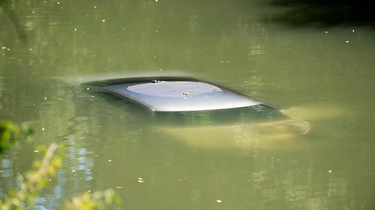 City of Merced Fire and Rescue crews work to remove a vehicle from Bear Creek in Merced, Calif., on Wednesday, June 2, 2021. The vehicle was traveling westbound on North Bear Creek when it left the roadway, according to police. The driver and passenger were not injured.