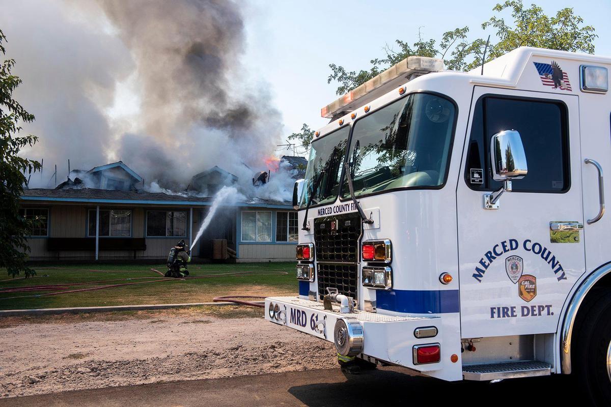 Cal Fire Merced County firefighters and City of Merced firefighters battle a structure fire which damaged two homes in the 1800 block of Dunn Road in Merced County, Calif., on Wednesday, Aug. 23, 2023. Fire officials said the cause of the fire is under investigation.