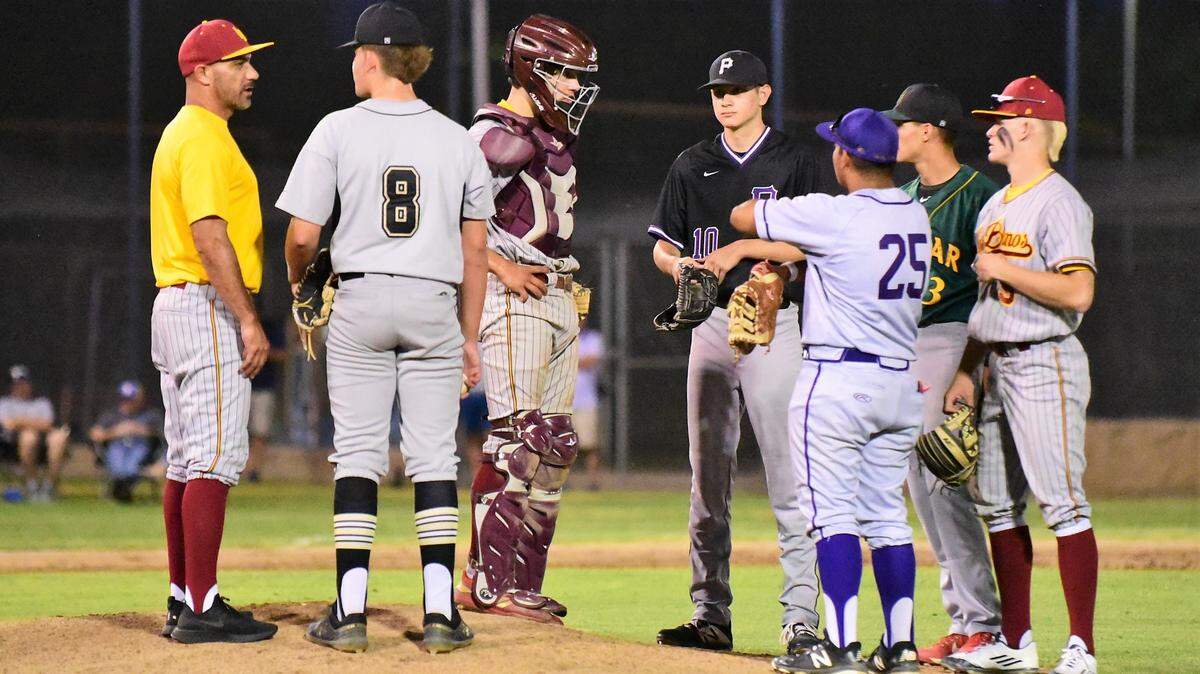 Los Banos High coach Pat Fuentes makes a trip to the mound to talk to Buhach Colony sophomore Jake Sapien as the rest of the North infield meets during the 10th annual Merced County All-Star Game on Saturday, June 8, 2019 at Merced College.
