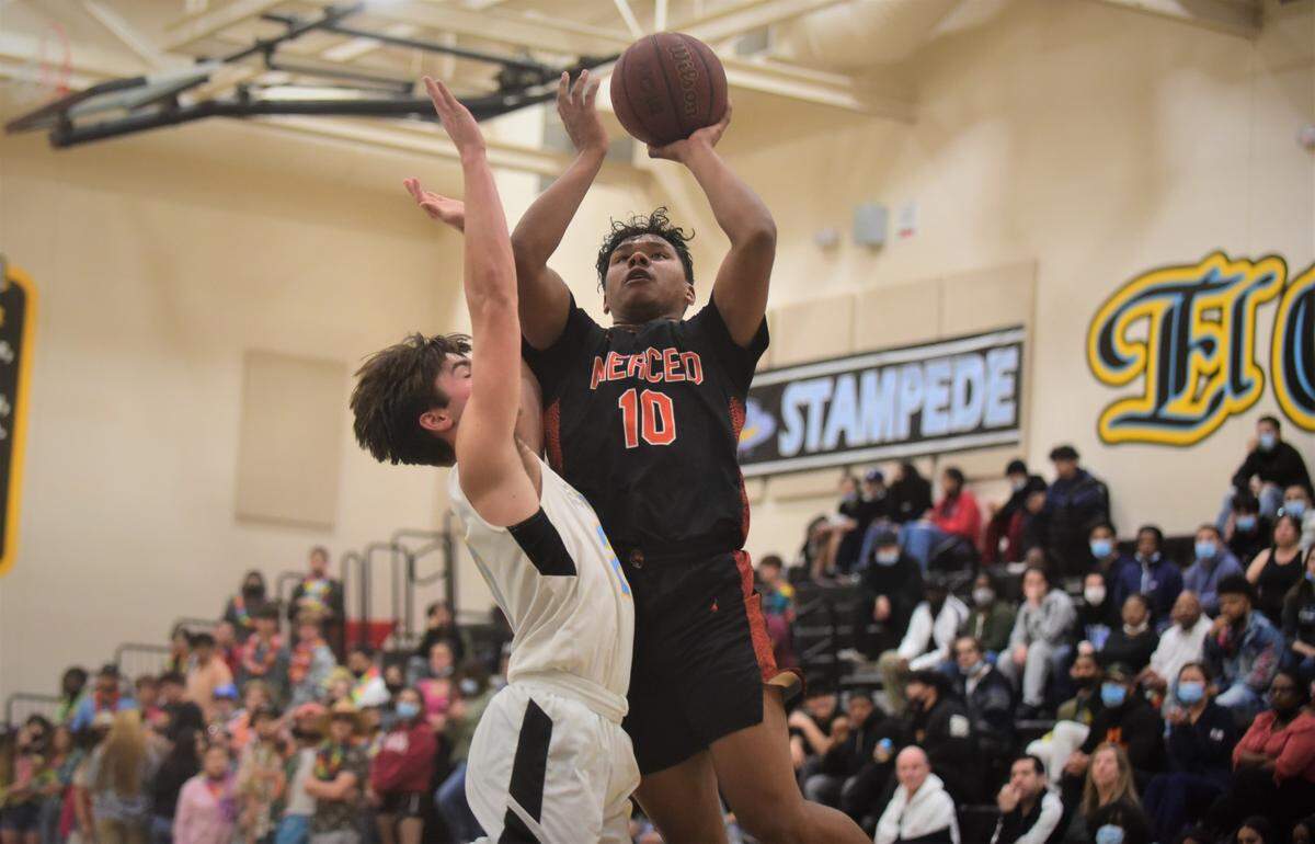 Merced High senior Jaylen Thao-Booth goes up for a shot against El Capitan junior Brody Collins during a game at El Capitan High School on Monday, Feb. 7, 2022.
