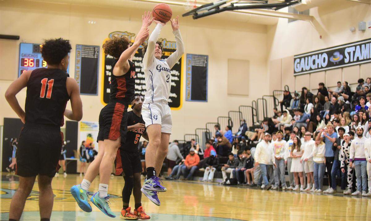El Capitan High School senior Will Bain (2) goes up for a shot against Merced’s Aiden Cervantes (1) during a game on Wednesday, Jan. 4, 2022 at El Capitan High School.