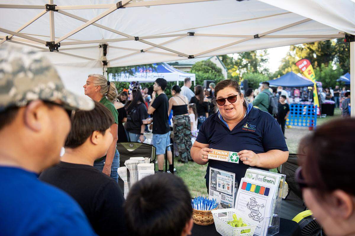City of Merced Recycling Coordinator Monique Gama, speaks with members of the community during the National Night Out event at Applegate Park in Merced, Calif., on Tuesday, Aug. 5, 2025. 
