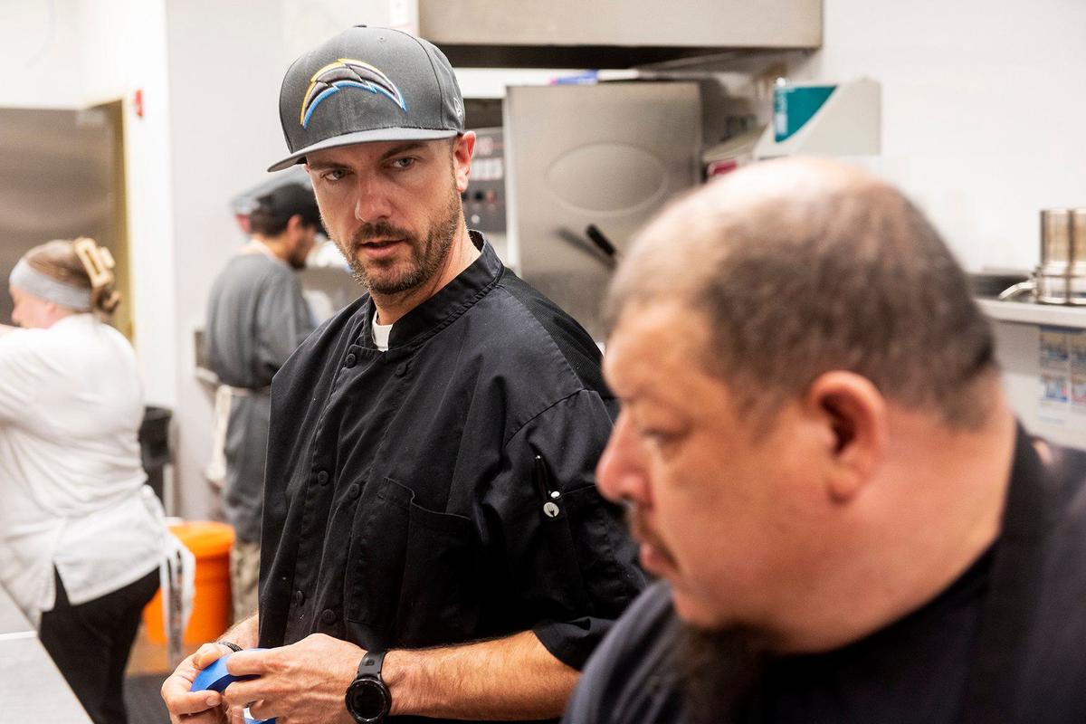 Executive Chef Evan Morrison, left, speaks with line cook Ron Reyes, right, at the historic Mainzer Theater in Merced, Calif., on Thursday, Aug. 15, 2024. A new menu crafted by Executive Chef Evan Morrison, is set to debut on Friday Aug. 16.