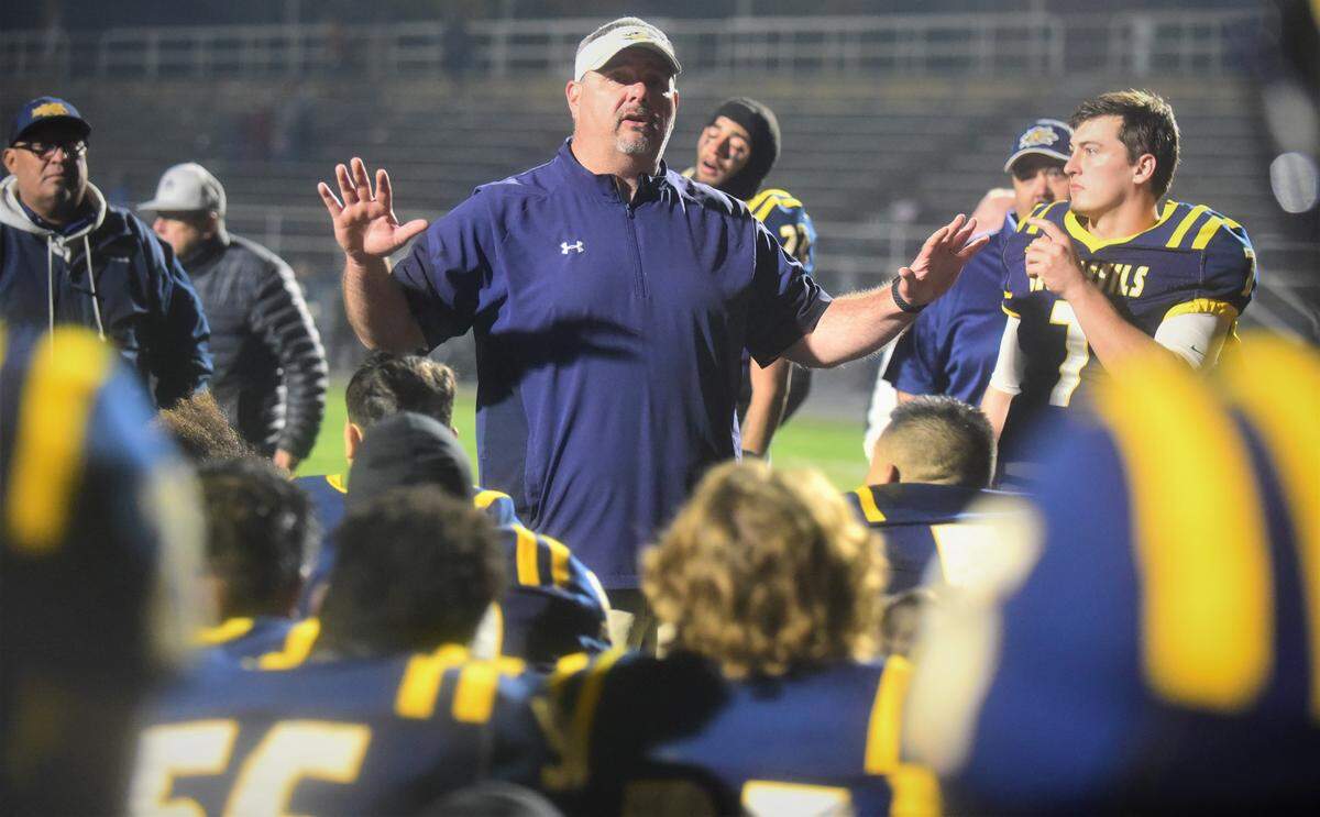 Merced College head coach Bob Casey talks to the Blue Devils players after a 40-39 overtime loss to College of the Sequoias in the Valley Center Bowl at Merced College on Thursday, Dec. 2, 2021.