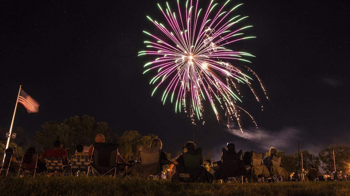 Fireworks explode over Castle Airport during the Castle Airport 4th of July celebration and fireworks show in Atwater, Calif., Saturday, July 4, 2015.