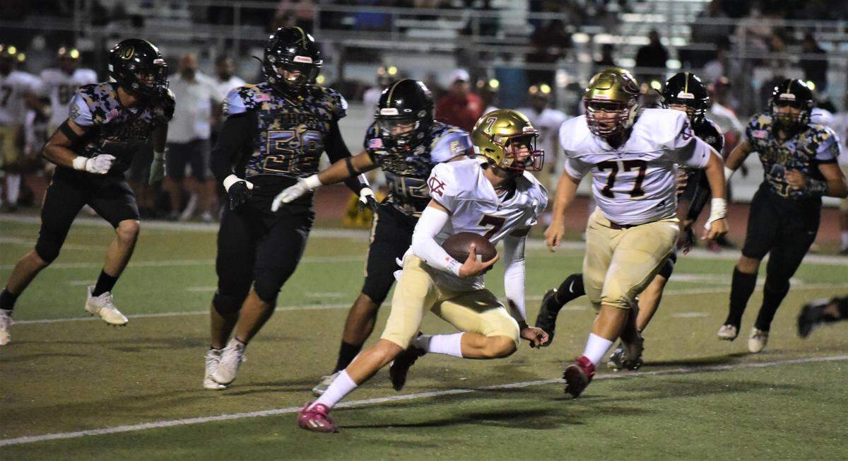 Golden Valley High quarterback Eleazar Garza runs the ball during a game against Buhach Colony on Friday, Sept. 16, 2022 at Dave Honey Stadium in Atwater, Calif.