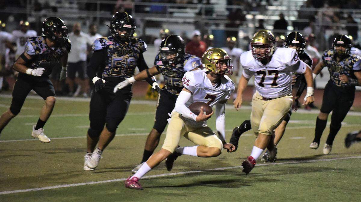 Golden Valley High quarterback Eleazar Garza runs the ball during a game against Buhach Colony on Friday, Sept. 16, 2022 at Dave Honey Stadium in Atwater, Calif.