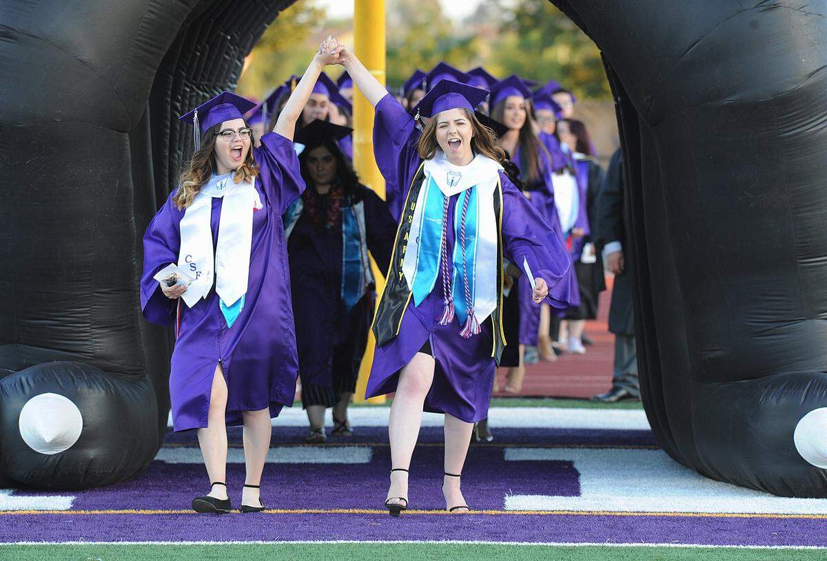 Pacheco High School graduates celebrate as they enter Veterans Stadium at Pacheco High during the June 1, 2018 graduation ceremony in Los Banos.