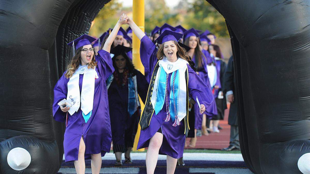 Pacheco High School graduates celebrate as they enter Veterans Stadium at Pacheco High during the June 1, 2018 graduation ceremony in Los Banos.