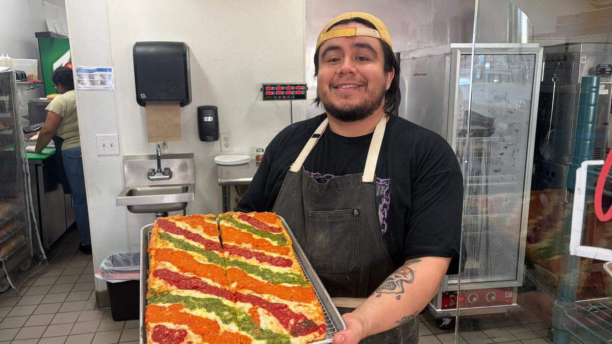 Manager Marco Alcocer shows off one of his specialty pizzas at Lovers Deli in Merced, Calif., on Thursday, Jan. 15, 2026.