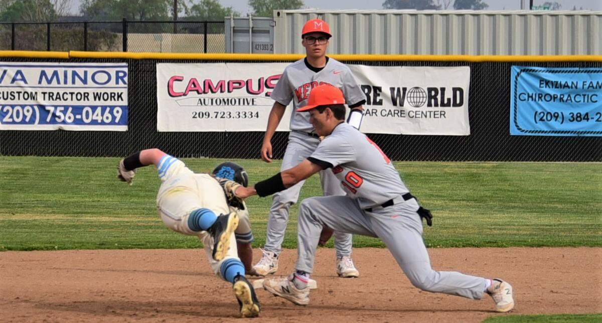 Merced High sophomore Riley Dickey tags out El Capitan’s Dylan Rogers at second base during a game at El Capitan HIgh School on Wednesday, March 30, 2022.