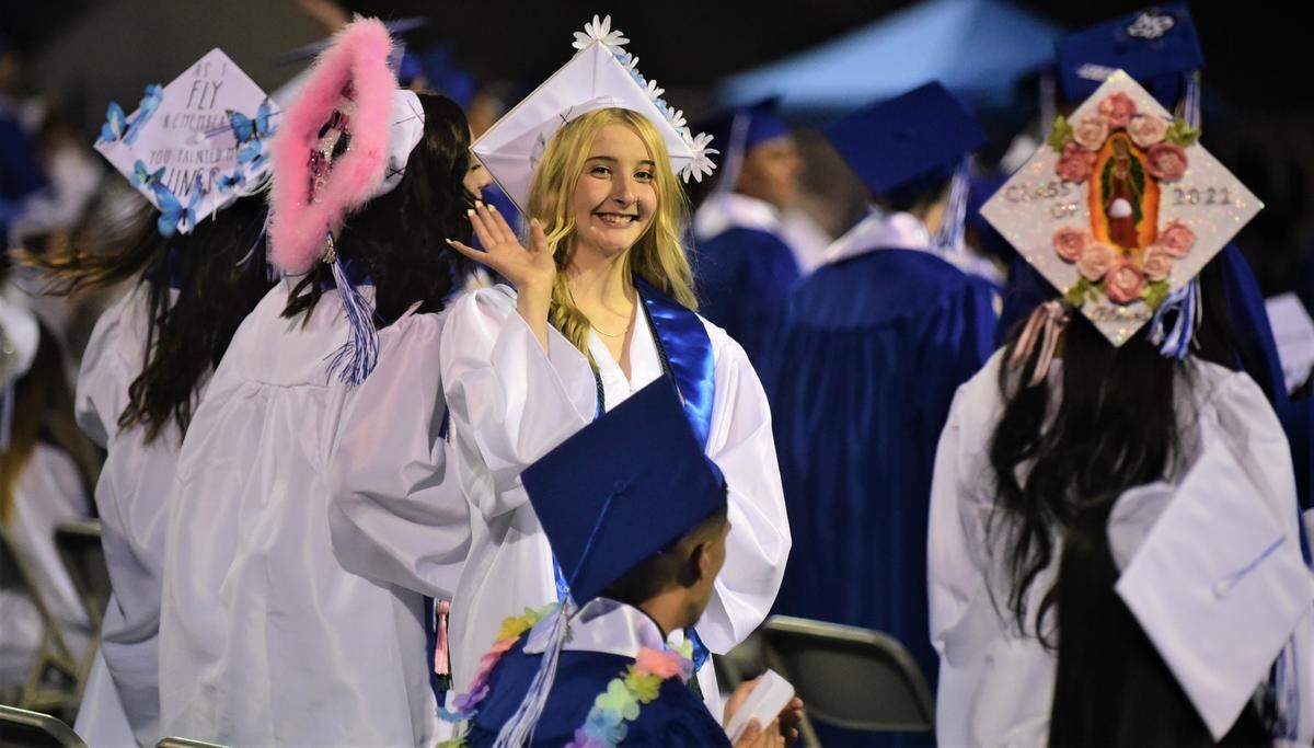 Atwater High School senior Lexi Garcia waves to her family during the Atwater High School graduation ceremony on Thursday, June 2, 2022 at Dave Honey Stadium.
