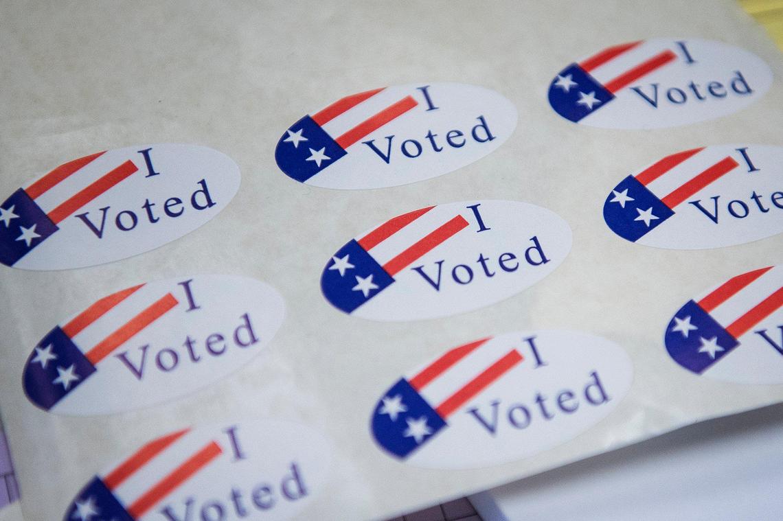 Stickers like these were handed out to voters at a polling location in the Merced County Administrative Building in 2020.