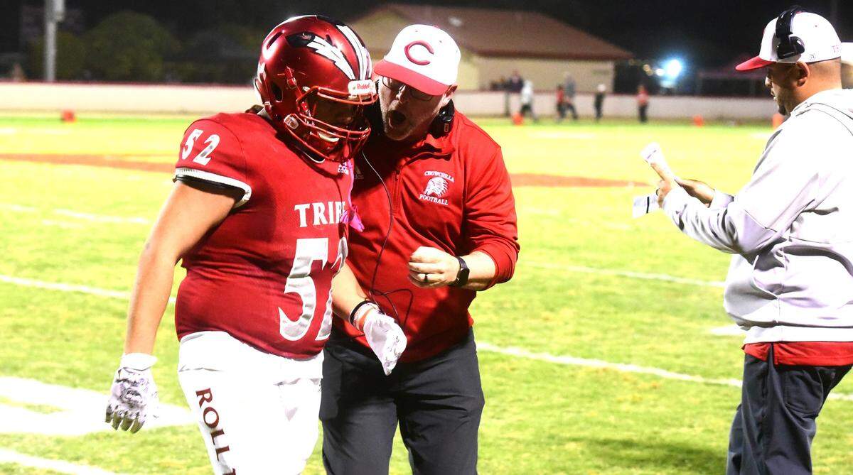 Chowchilla High football coach Alex Pittz (right) talks to sophomore linebacker Miguel Gomez (52) as Gomez comes off the field during a game against Minarets on Friday, Oct. 18, 2024.