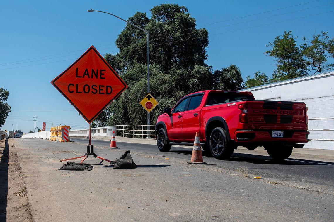Motorists navigate a lane closure on the Bear Creek Bridge near the intersection of West 16th Street and Highway 59 in Merced, Calif., on Friday, July 18, 2025. A lane of the bridge has been closed in each direction as crews work to complete a California Department of Transportation seismic retrofit project in Merced County.