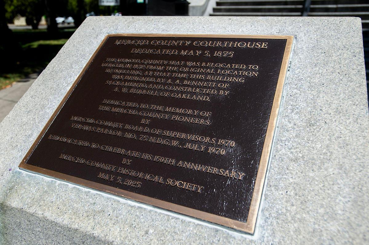 A newly installed plaque is unveiled during a rededication ceremony for the historic Merced County Courthouse in Merced, Calif., on Monday, May 5, 2025. The ceremony was held 150 years to the day from when the courthouse was originally dedicated in 1875.