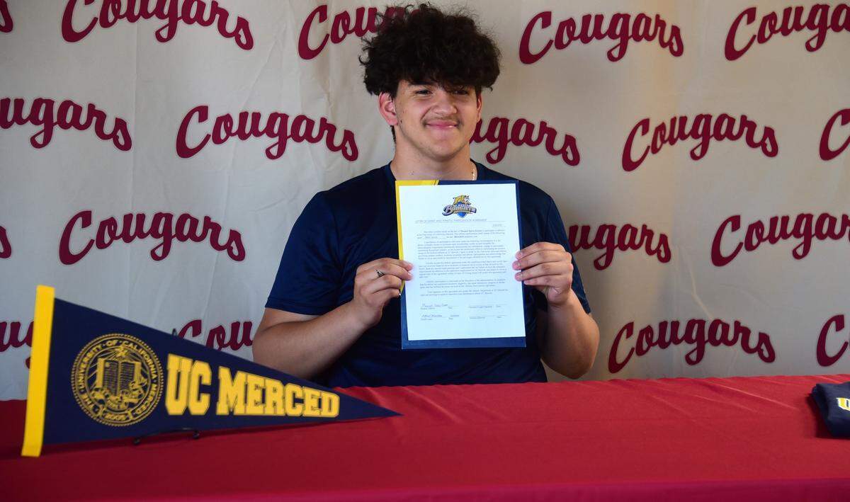 Golden Valley High School senior goalie Manuel Zarco-Zarate holds up his national letter of intent he signed to play at UC Merced during a ceremony on Wednesday, May 29, 2024 at Golden Valley High School.